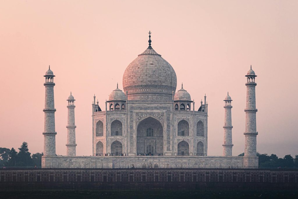 Beautiful view of the Taj Mahal at sunrise, showcasing its stunning architecture and historical significance.
